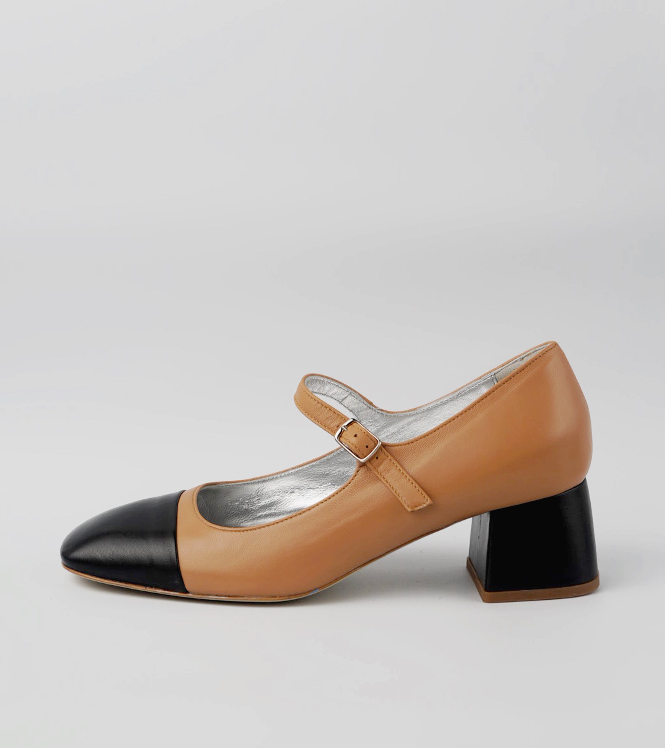 Brown and black shoe on a light gray background #color_palermo tan milano black