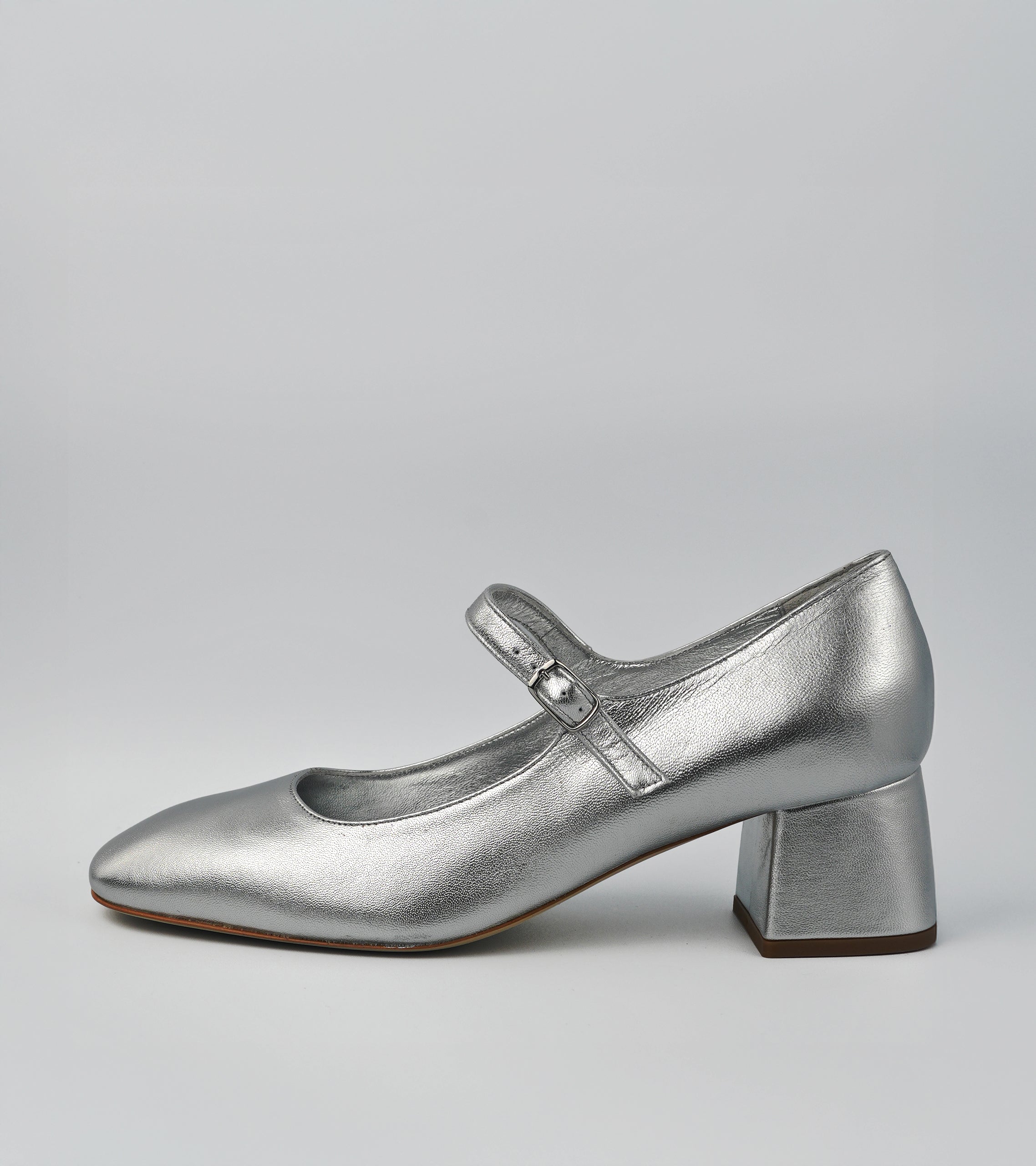 Silver shoe with a block heel on a gray background #color_napoli silver