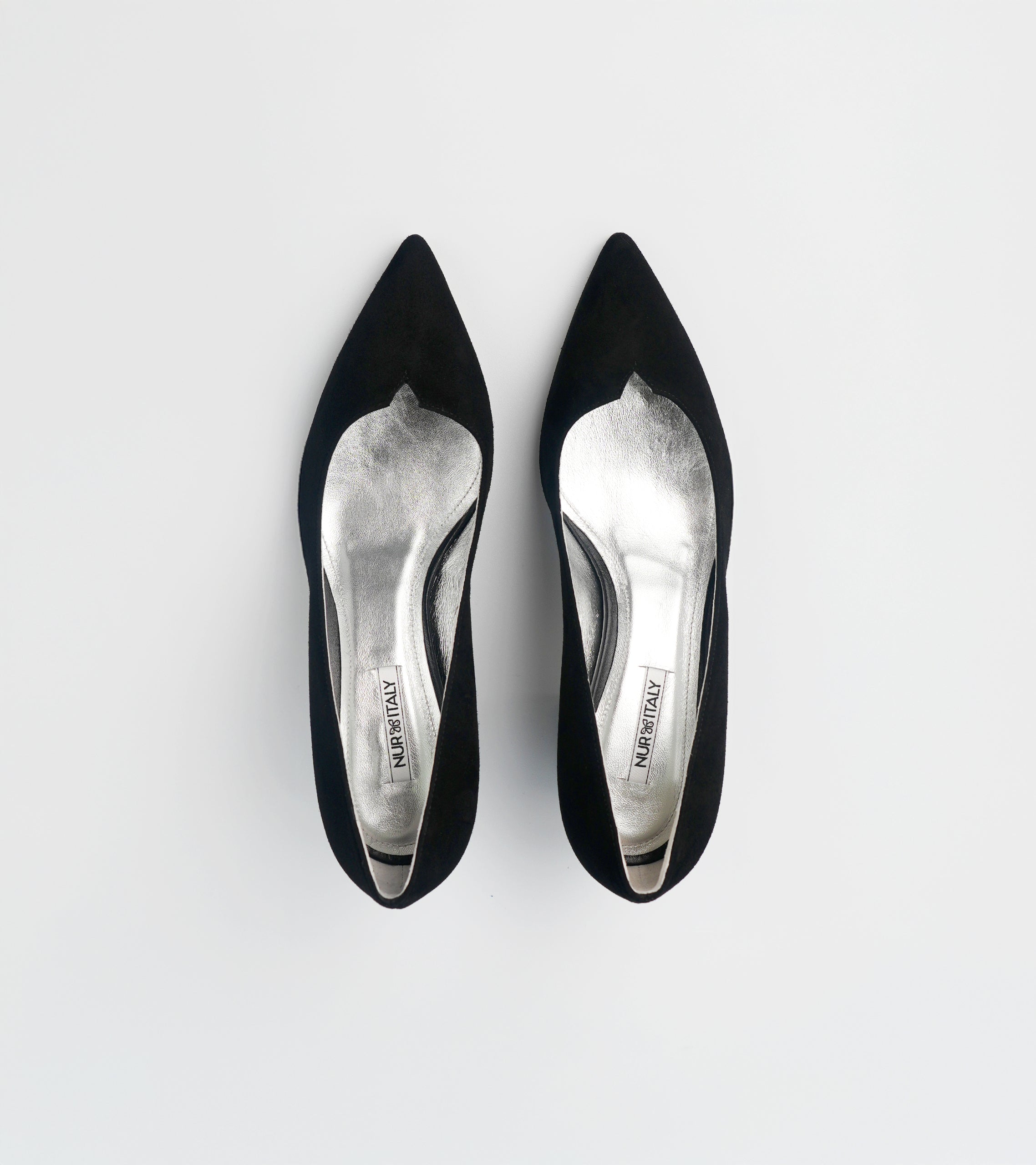 Pair of black pointed-toe high heels on a light gray background #color_milano black
