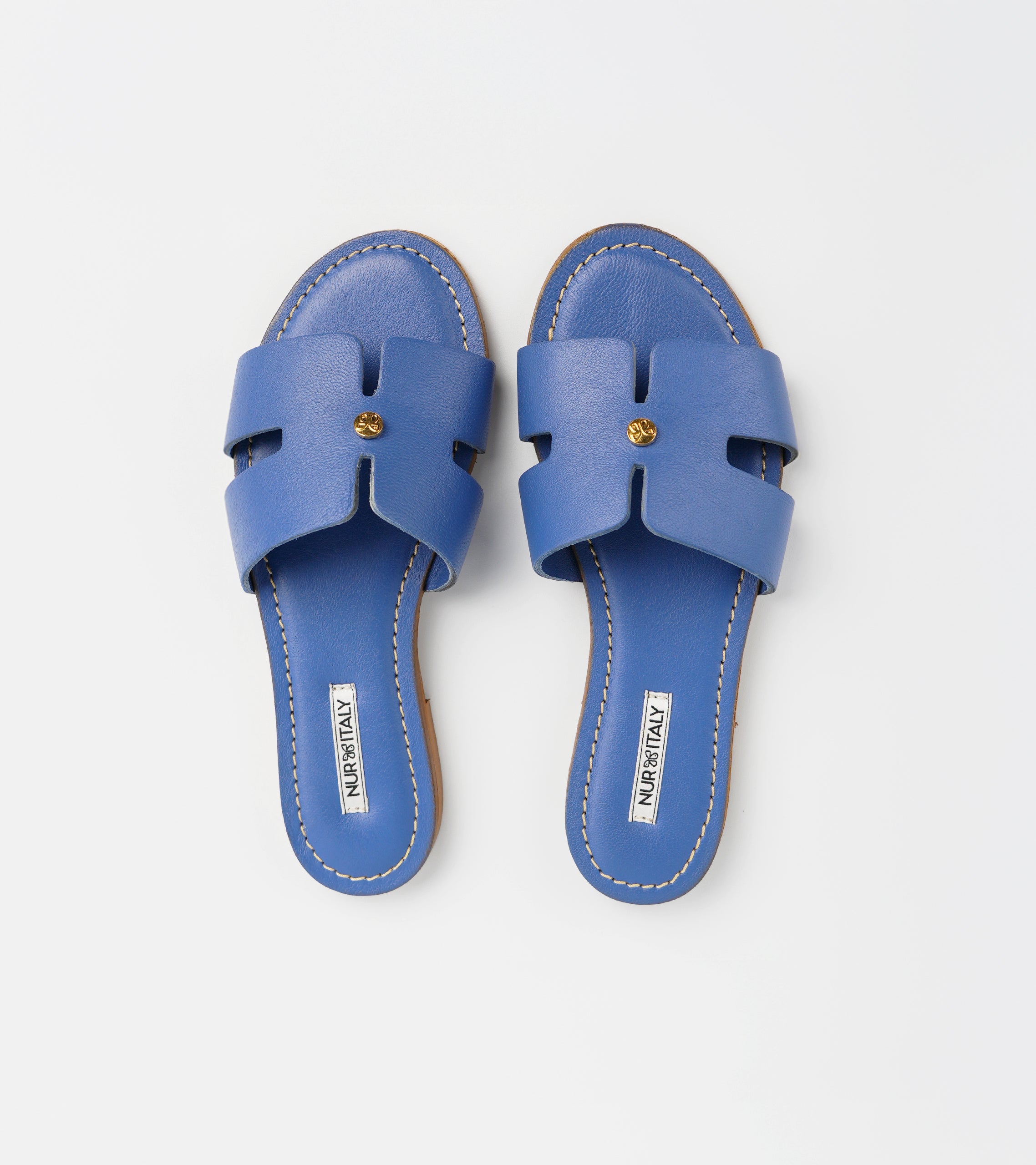 Pair of blue sandals on a light gray background #color_capri blue