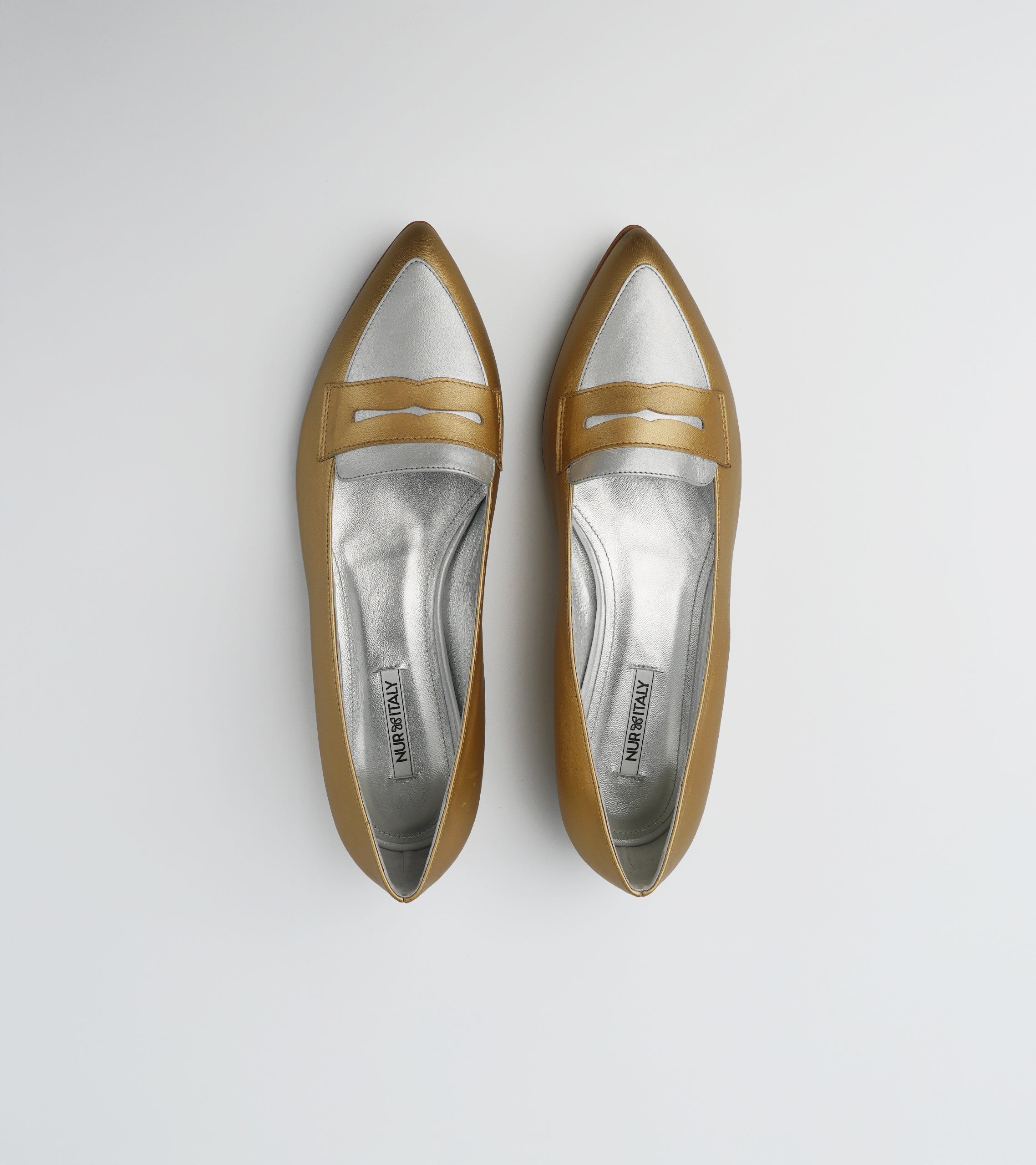 Pair of gold and silver pointed-toe flats on a light gray background #color_venezia gold napoli silver
