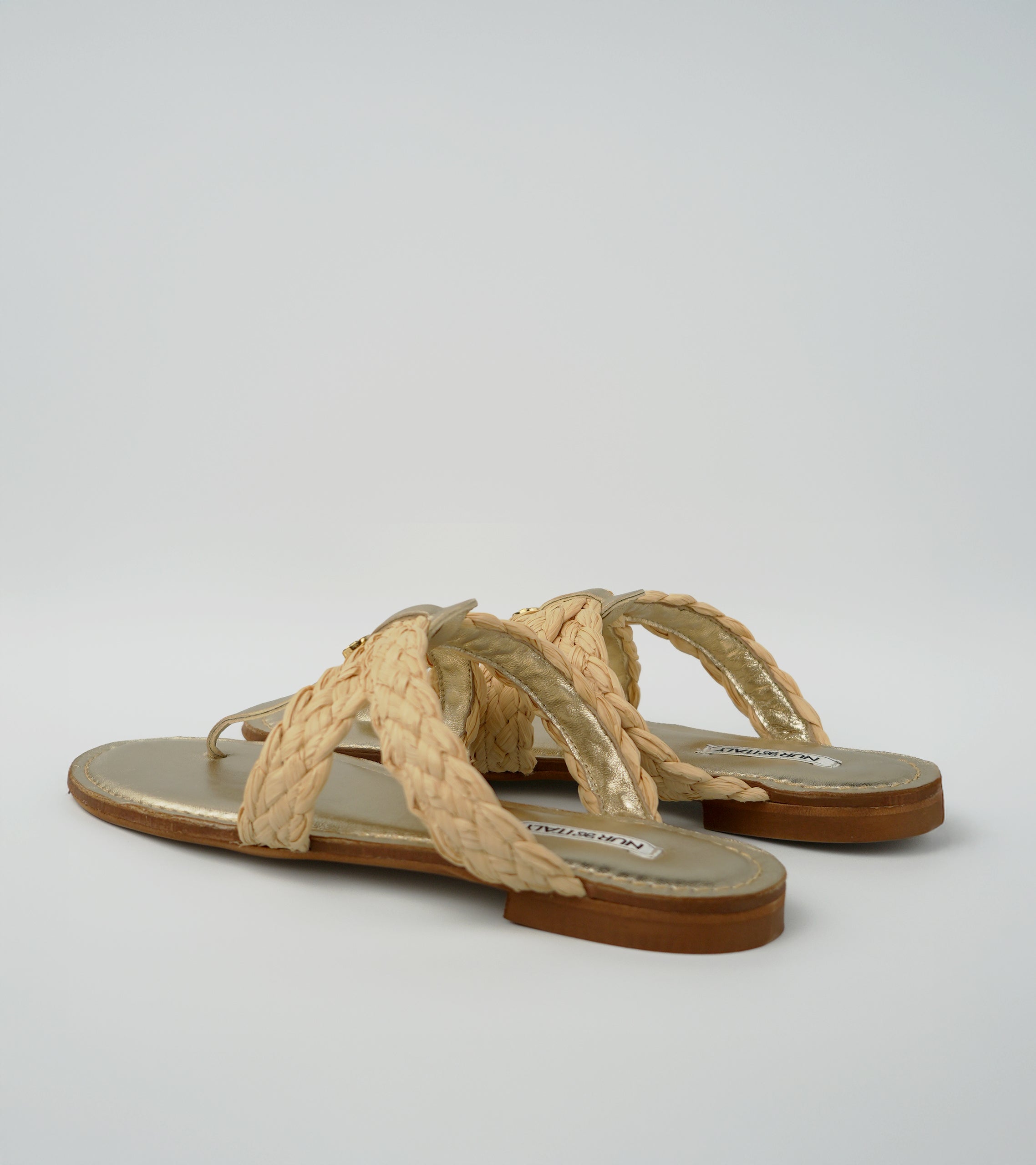 Pair of beige sandals with woven straps on a light gray background #color_venezia gold