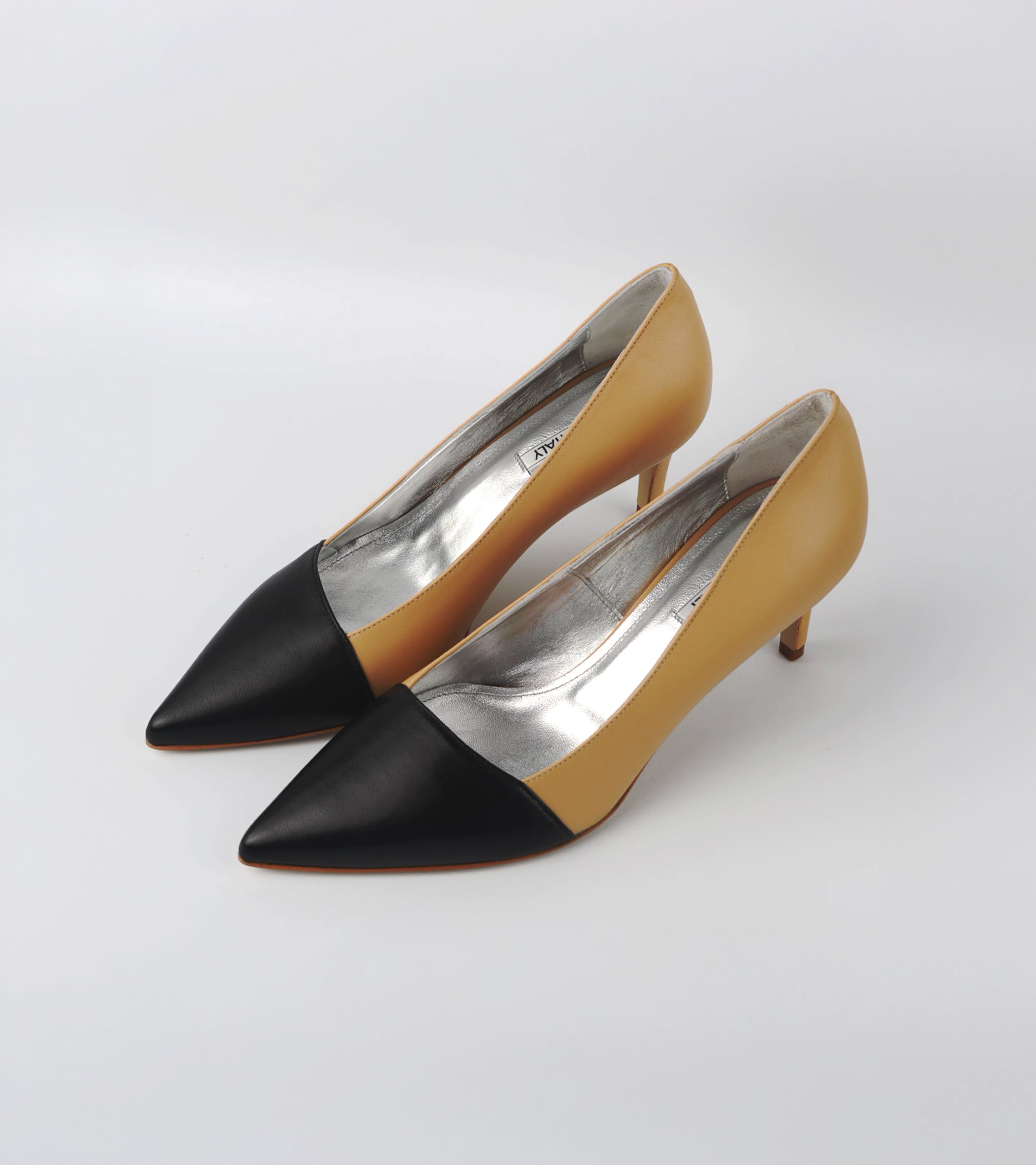 Pair of high-heeled shoes with black and beige design on a white background #color_grosetto nude