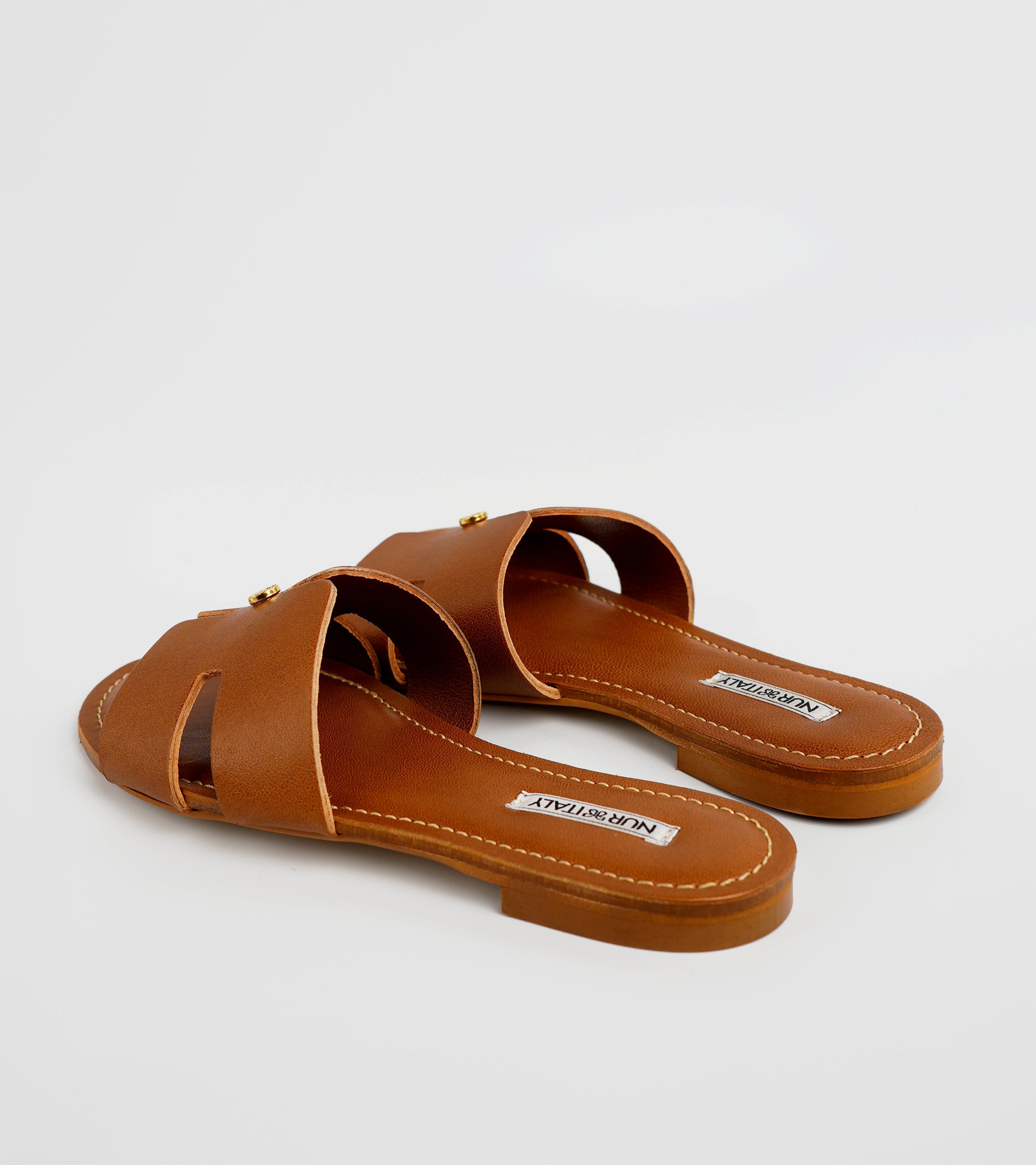 Pair of brown sandals with 'Mango' label on a white background #color_palermo tan