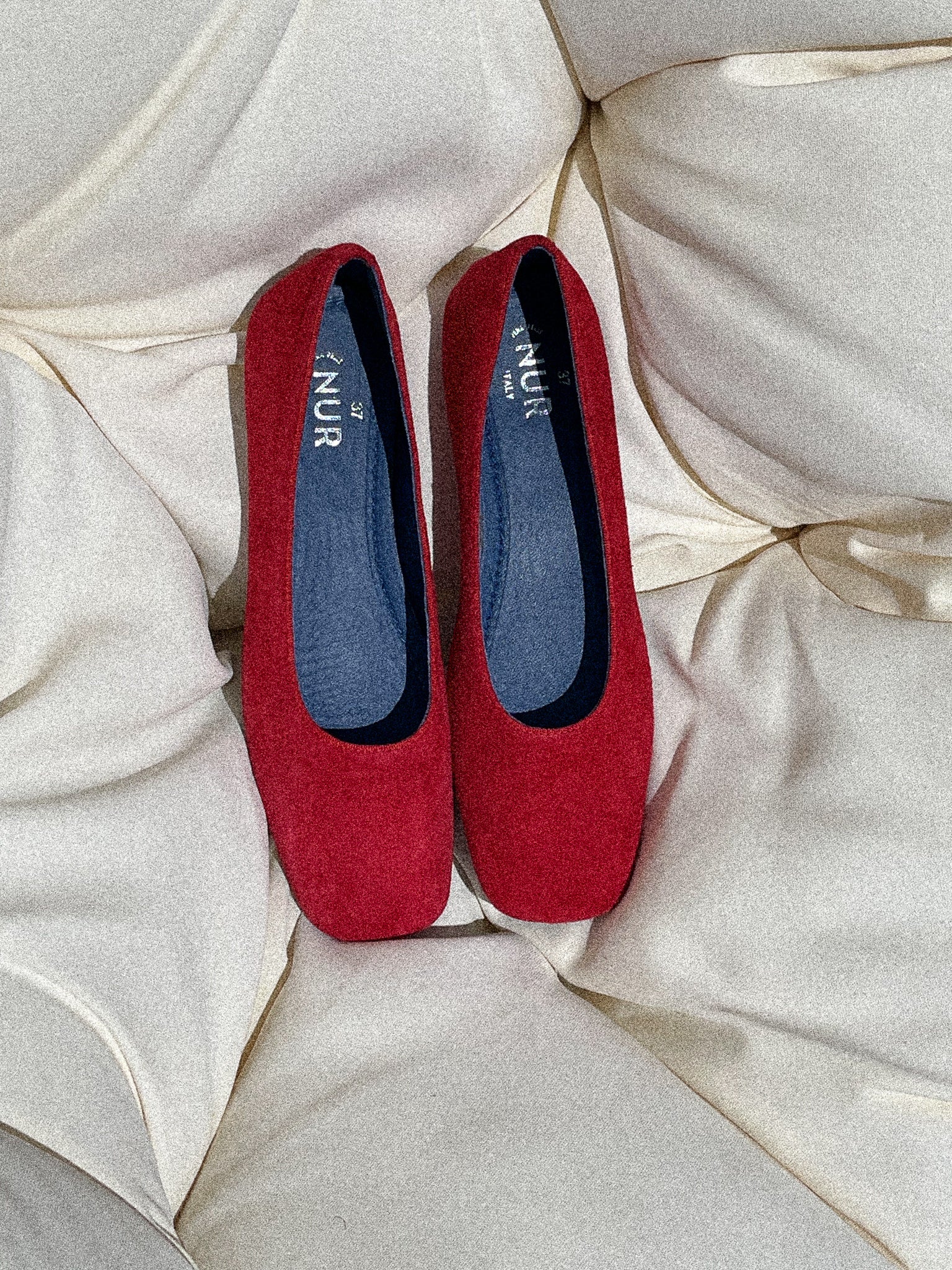 Giulia Suede Square-Toe Ballerina Flat on a couch under the sun, Color, RED #color_varese fire